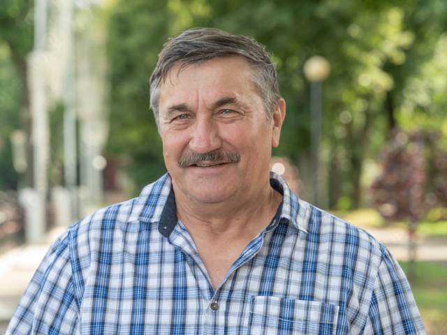 Middle-aged man with a mustache wearing a blue plaid shirt